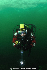Diver investigating a jelly by Henrik Gram Rasmussen 